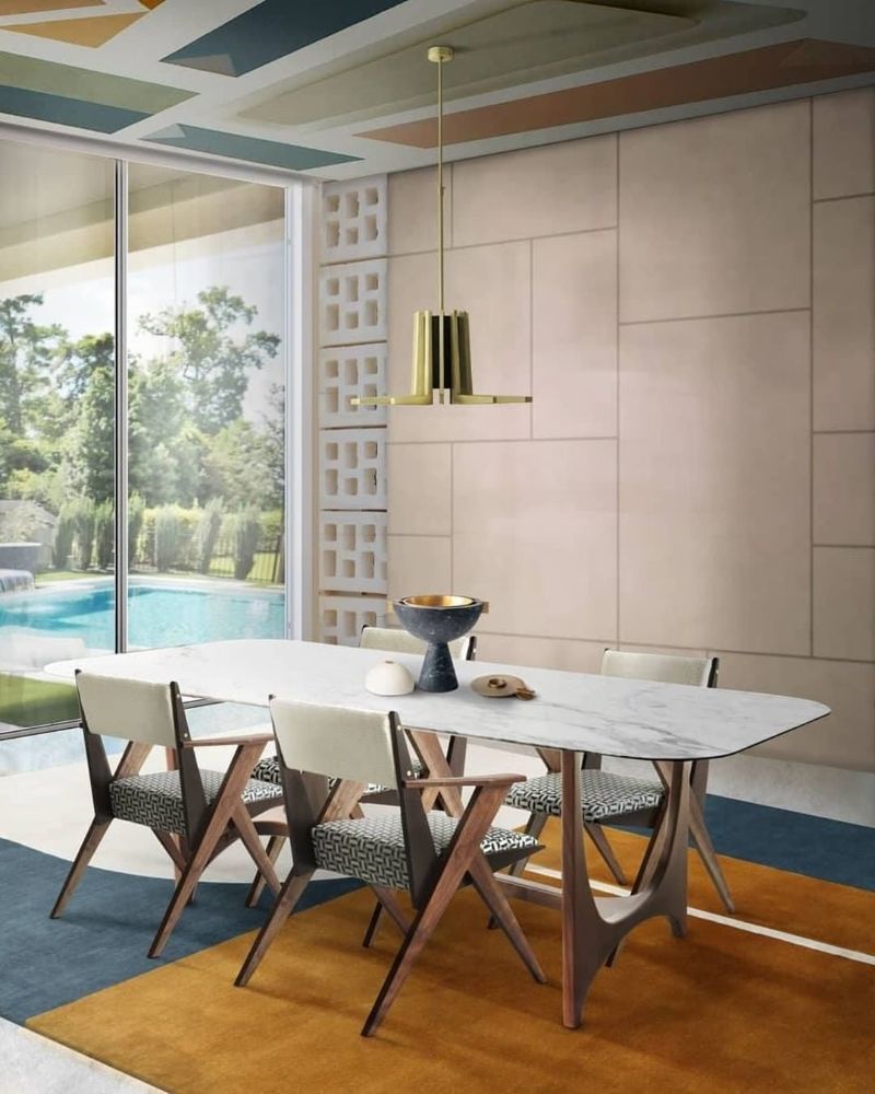 mid-century dining room with Antelope rug, gold suspension light and dinign chairs