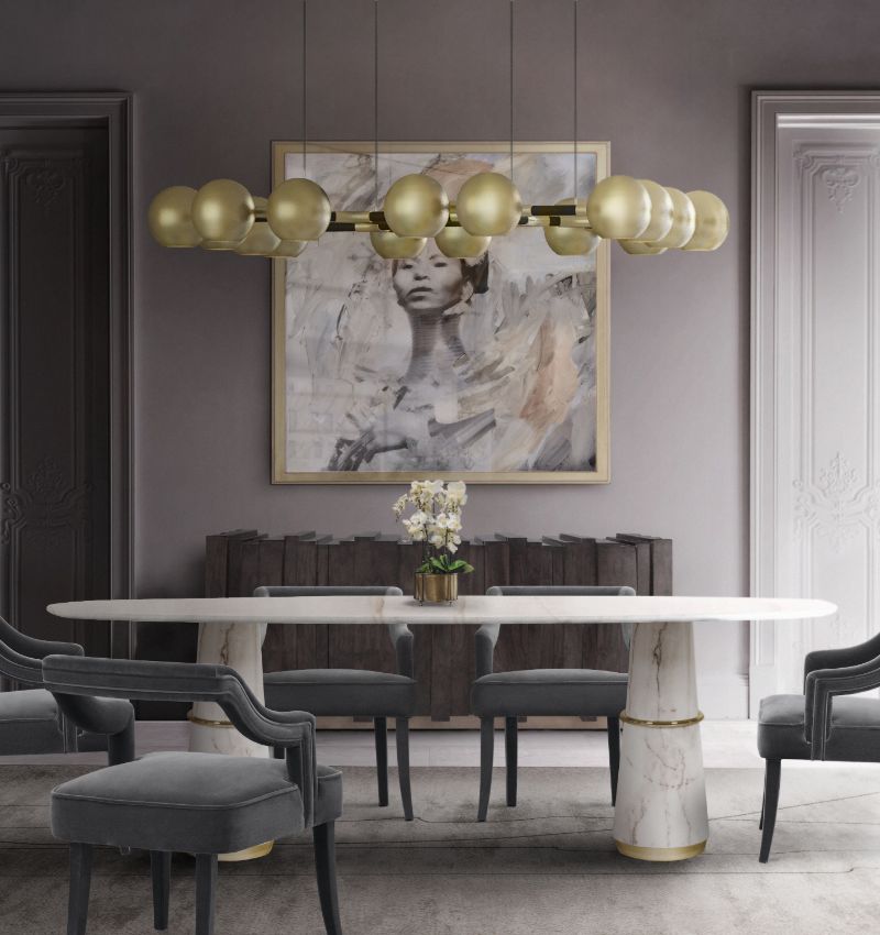 This modern contemporary rug highlights the marbled dining table and the velvet dining chairs. The gray colors create a sense of tranquility in this dining room.