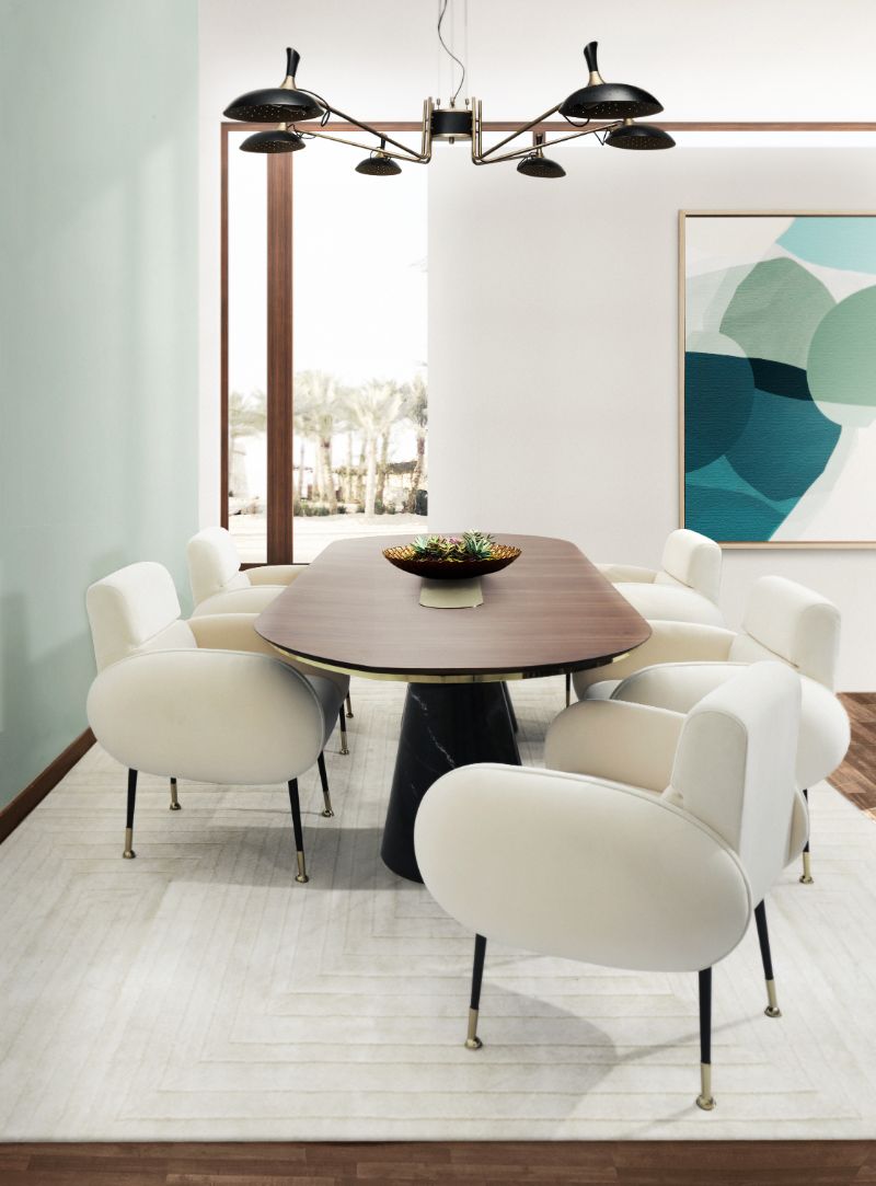 Modern contemporary dining room with White Garden Rug and white dining chairs, a black oval dining table