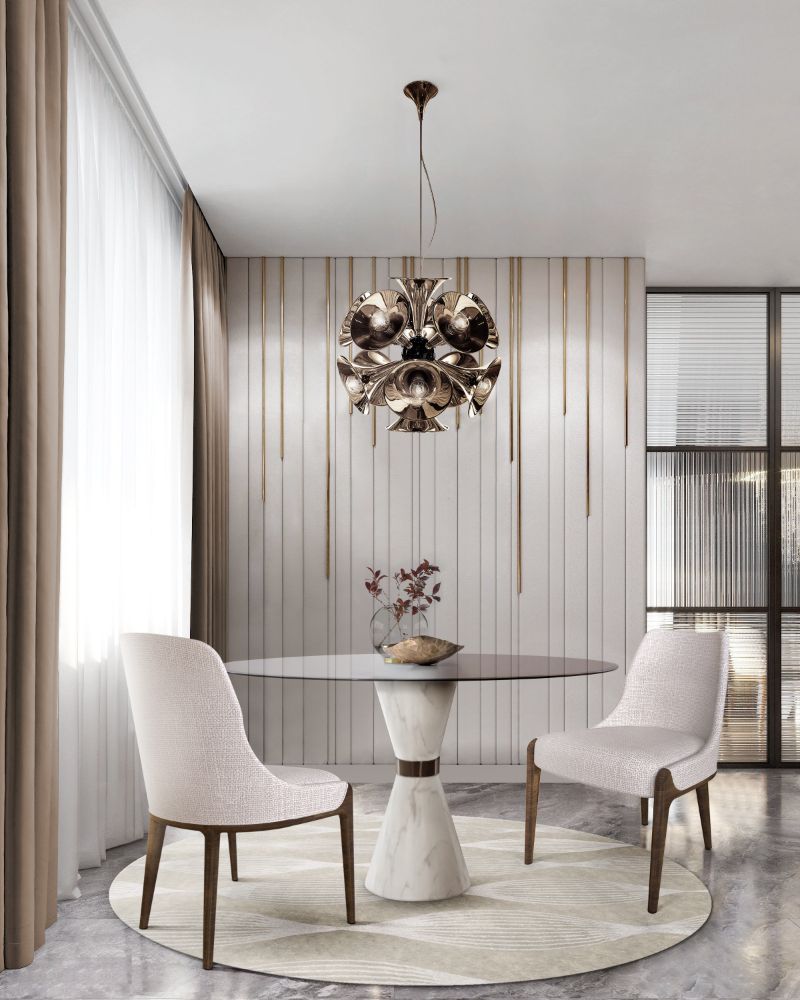 Round dining room rug with white chairs and round dining table and gold hanging light
