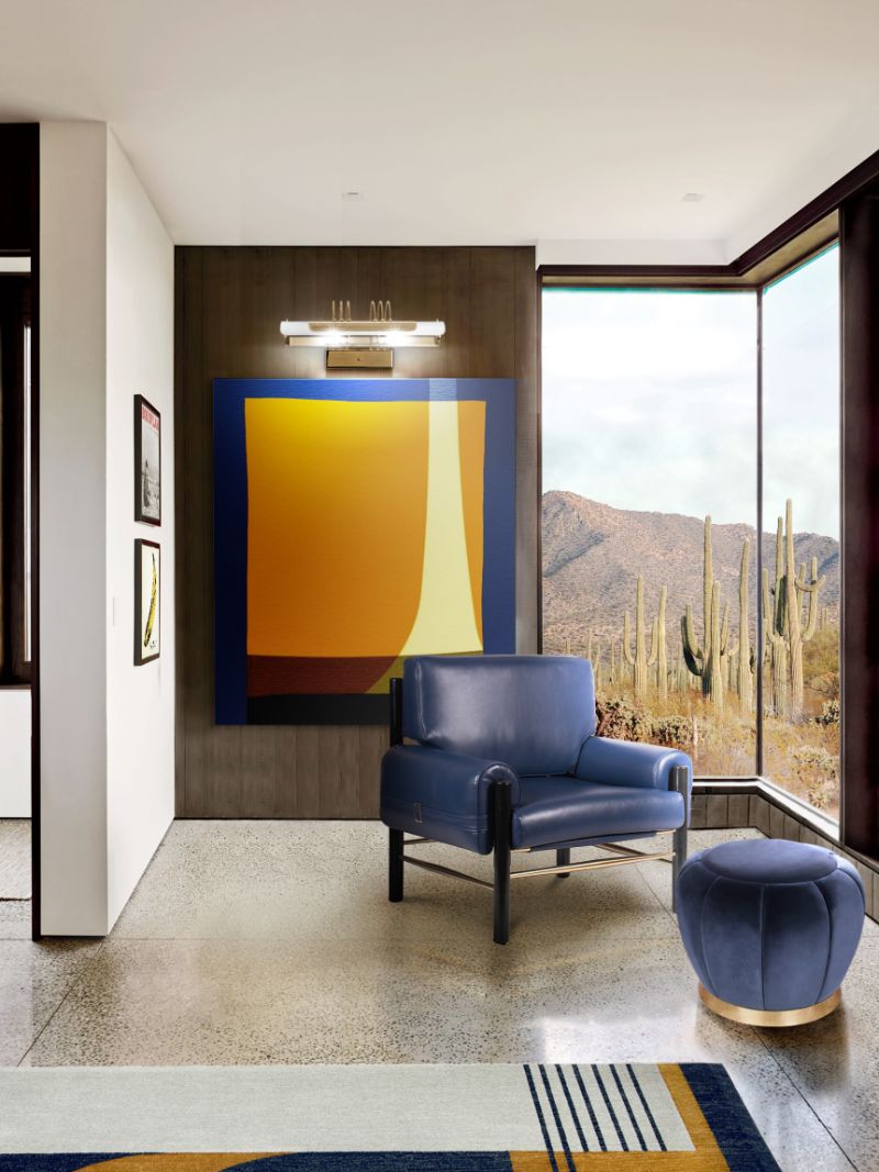 colorful living room in blue tones with antelope rug and armchair.