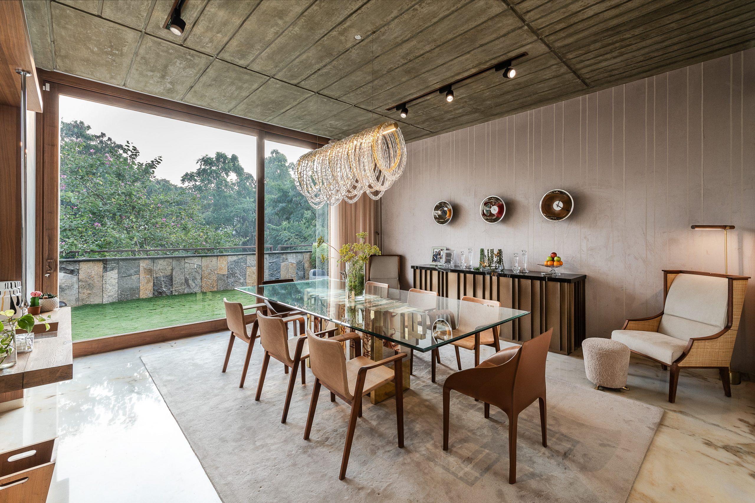 Modern dining room with beige rug and suspension lights