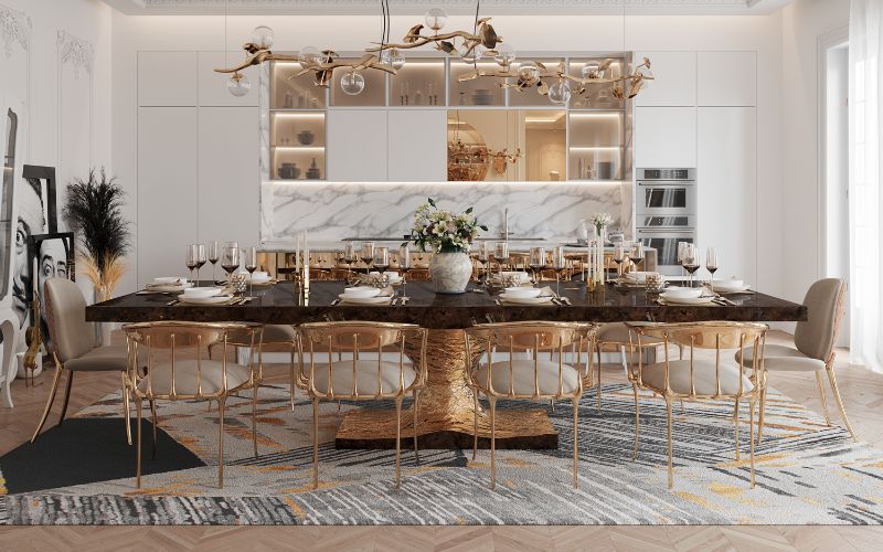 stunning dining room with Xisto rug in gray and white with a touch of gold. Dining chairs in gold and dining table