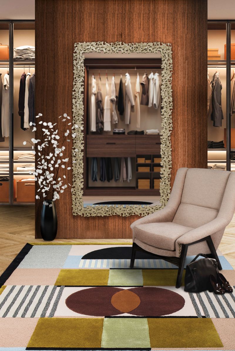 Luxurious closet with Issac Rug with rectangular gold mirror and beige armchair