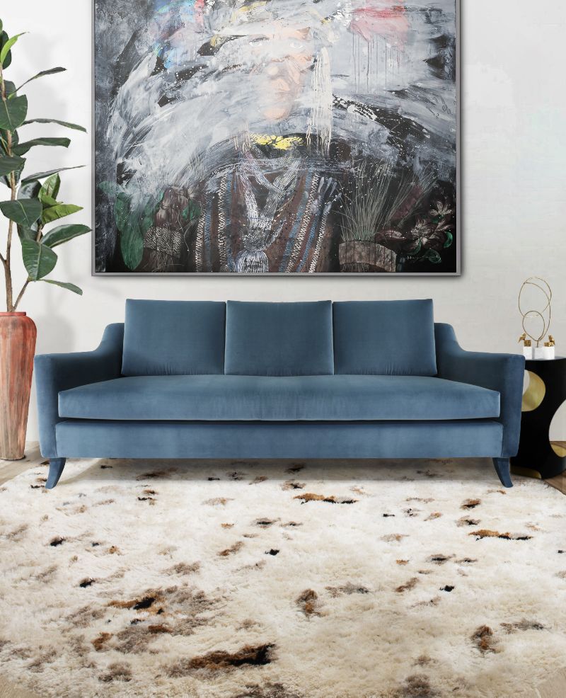 contemporary living room with blue sofa with oslo rug