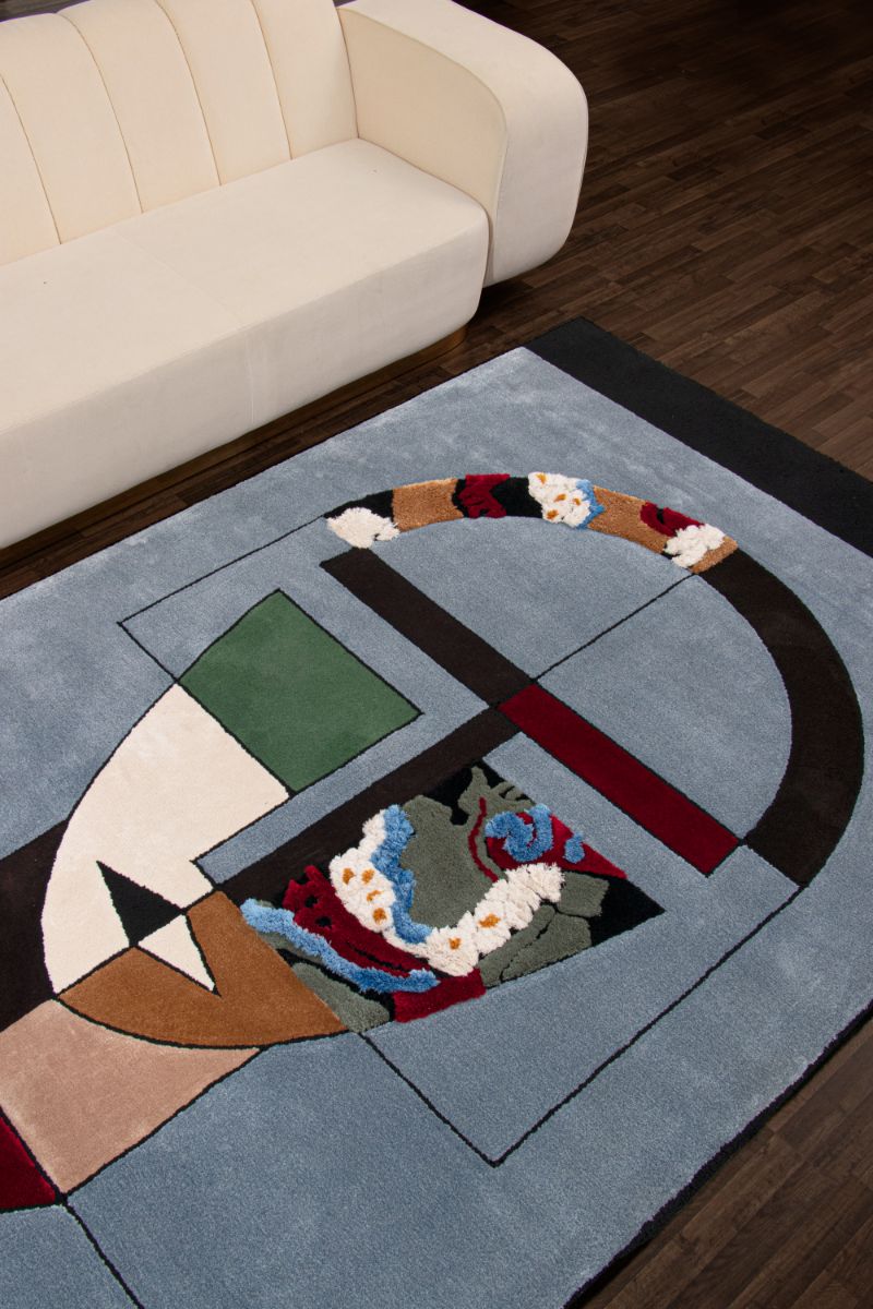 Artistic blue rug that ornaments this living room with geometric shapes that create a human face. Modern Interior Design Tips: The Best Modern Contemporary Rugs