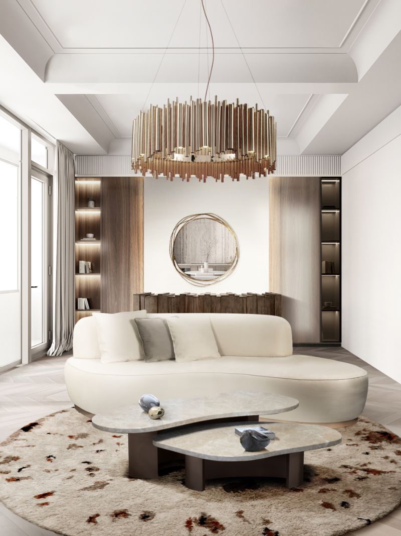 Sophisticated living room decor with a round rug and white sofa with gold suspension lights.