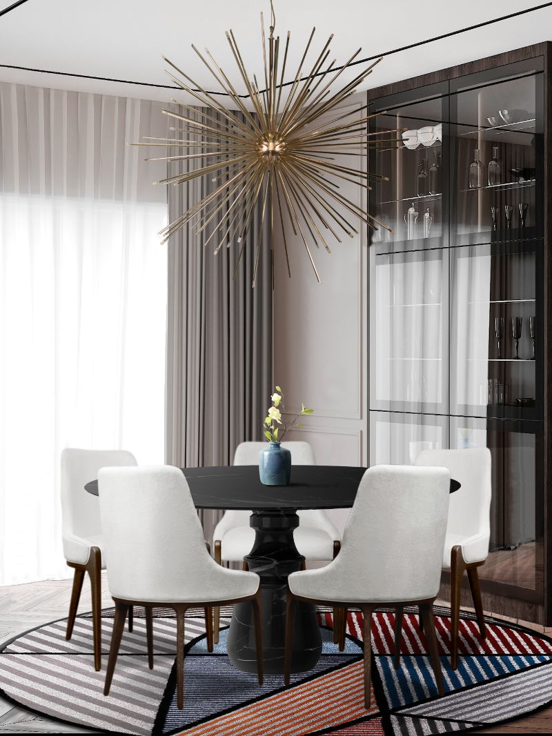 a small dining room with a geometric round rug that has a colorful design and pairs with the round dining table. What Are The Rug Trends For 2022?