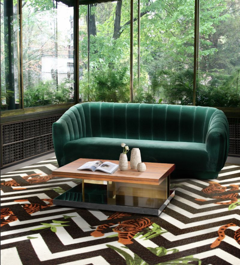 Geometric Rugs with black and white rug and dark green sofa.