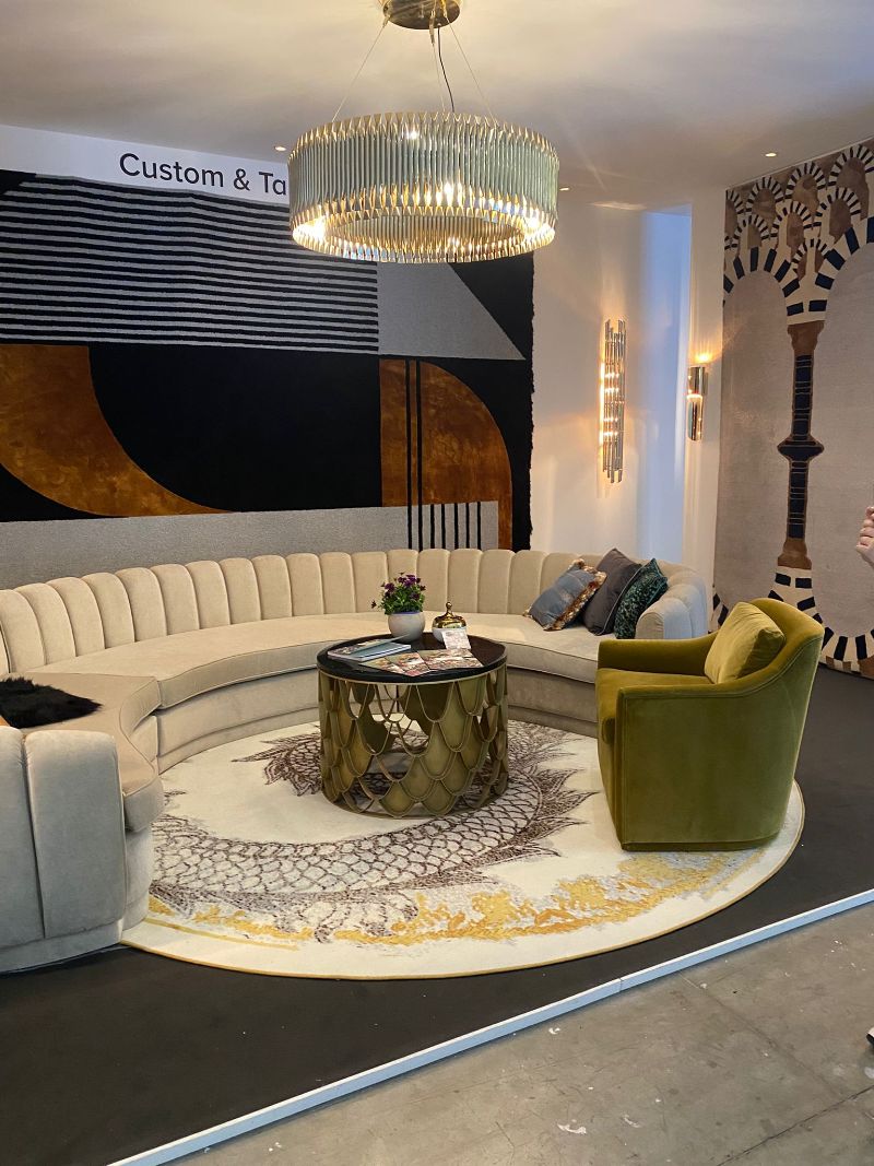 Where To Find The Finest Luxury Rugs at iSaloni 2022, with round rug in gold and silver hues, curved sofa and center table with armchair