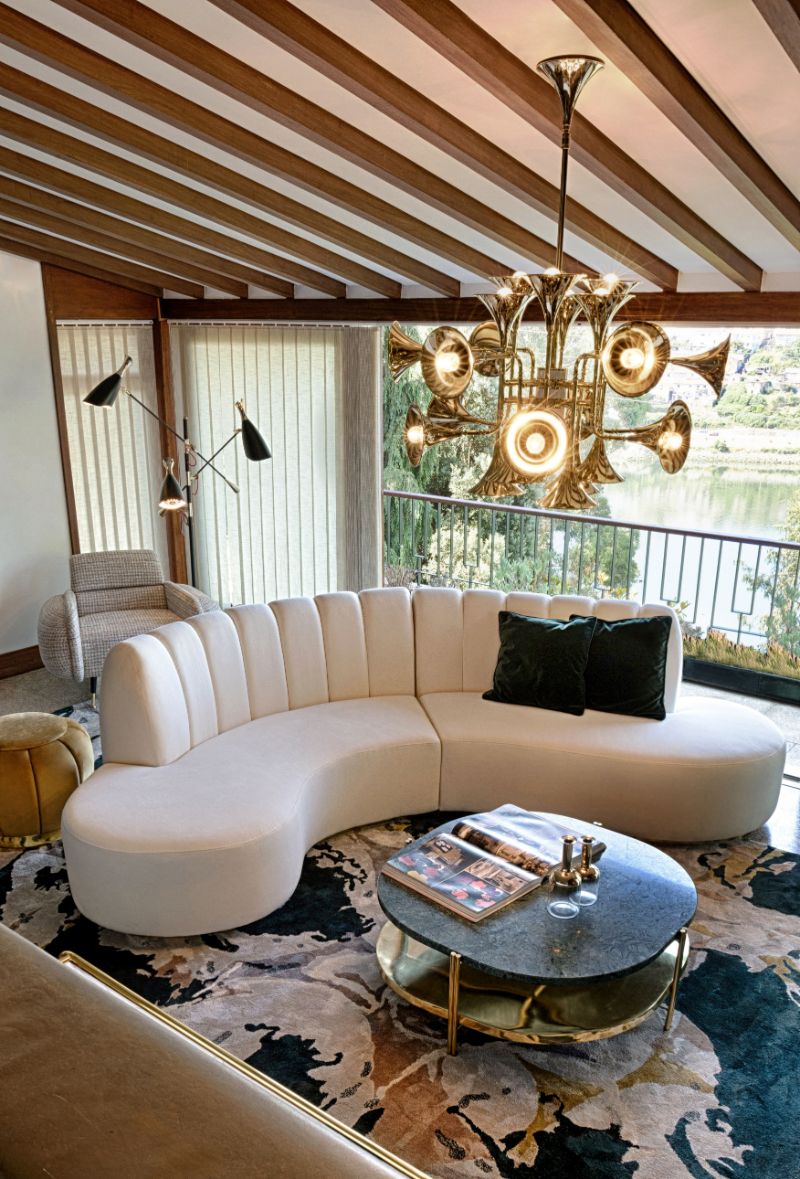 12 Rug Styling Ideas You Should Consider For Your Home. Cozy contemporary mid-century living room with blue area rug called Madeira and curved sofa