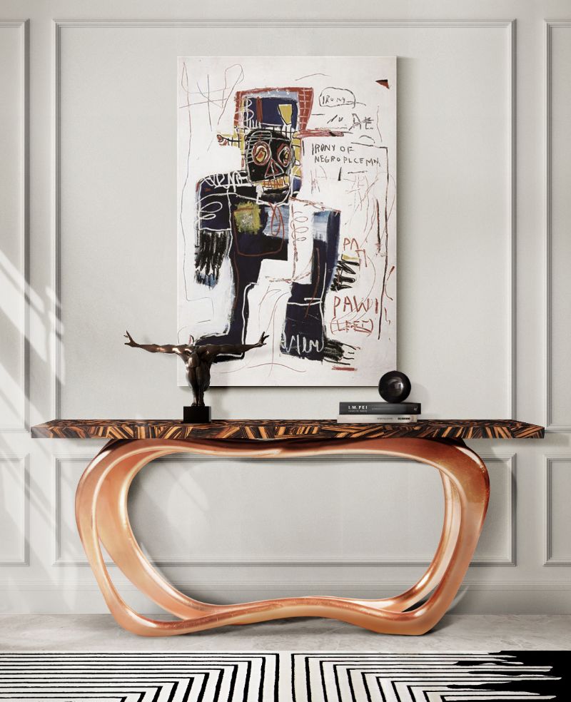 console for entryway with golden accents and black and white rug.