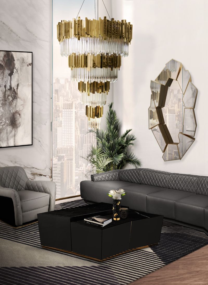 a modern contemporary living room in gray with a geometric rug and ceiling light pendant chandelier